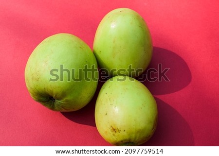Fresh and organic Indian fruit called Green jujube or Apple jujube or Ber apple. Green Indian jujuba plum bora on red background Stock fotó © 