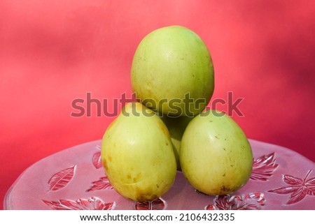 Fresh and organic Indian fruit called Green jujube or Apple jujube or Ber apple. Green Indian jujuba plum bora on red background Stock fotó © 