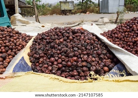 Selective focus of dried jujube jungli Ber sold in Vegetable market. Bora or Ber wild jungle fruit selling by villagers big heap wholesale market in a Village road side highway in Maharastra India Stock fotó © 