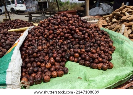 selective focus of jujube jungli Ber sold in Vegetable market. Bora or Ber wild jungle fruit selling by villagers big heap wholesale market in a Village road side highway market in Maharastra India Stock fotó © 