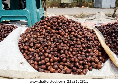 Selective focus of Indian dried jujube jungli Ber sold in Vegetable Sunday market. Bora or Ber wild jungle fruit selling by villagers big heap wholesale market in a Village road side highway market Stock fotó © 