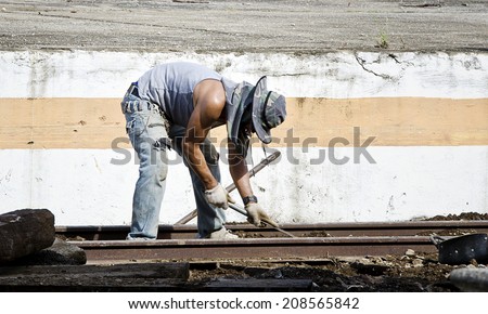 CHIANG MAI,THAILAND - AUGUST 2: Thai worker repairing railway at Chiang mai railway station on August 2,2014.