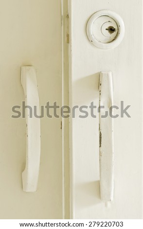 Vintage handle of white cabinet,close up view.