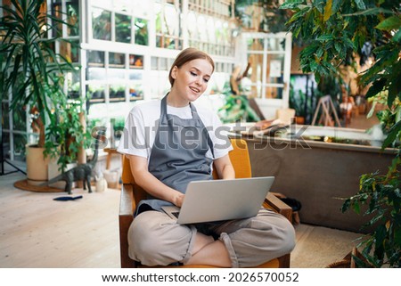 Similar – Image, Stock Photo Concentrated female cashier in face mask working with cash till