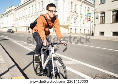 Similar – Image, Stock Photo Young man riding bicycle