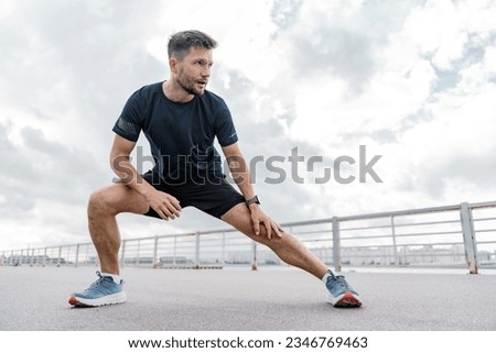 Similar – Image, Stock Photo Confident man exercising on cycling machine in gym