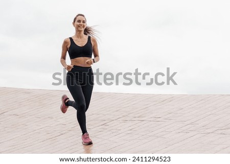 Similar – Image, Stock Photo Athletic woman running on paved street