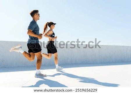 Image, Stock Photo Athletic woman running on paved street