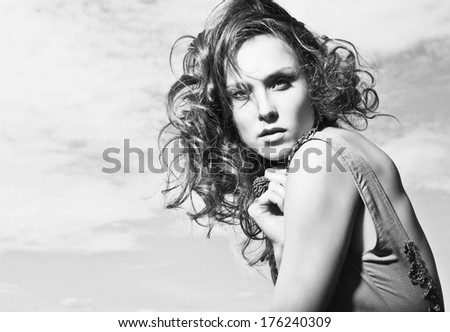 Sensual brunette woman with shiny curly silky hair