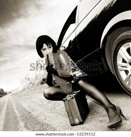 Sexy woman with baggage near to car