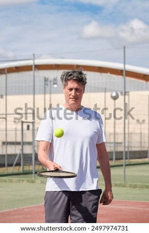 Similar – Image, Stock Photo Aged tennis player bouncing ball on racket