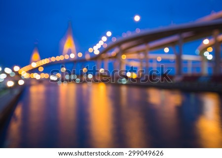 Abstract blurred bokeh light,highway intersection and the bridge waterfront at nigth