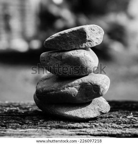 concept of balance and harmony. rocks on the wooden table. black white color tone.