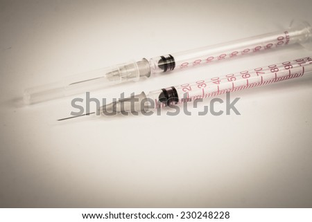Plastic syringe  on  white background duo tone.