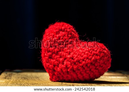red heart shape on wooden background with light and shadow of window, abstract background to love,valentine concept.