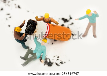 decoration of cigarette butt and miniatures workers no smoking concept.