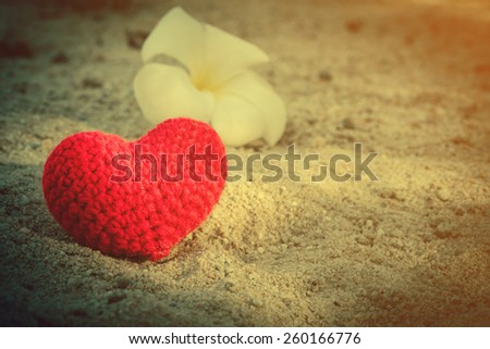 sweet heart on sand beach under sunset and warm light. abstract background love summer on the beach.