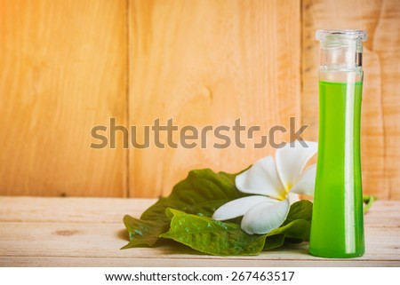 bottle of betel leaf oil extract on wooden floor.