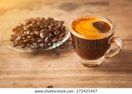 sweet morning with  espresso coffee on wooden table under soft light of sunrise