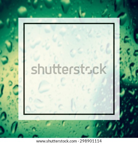 blank design frame label over blurred rain drop on window background,vintage color tone