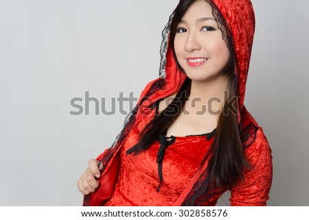 Asian girl wearing a red riding hood costume