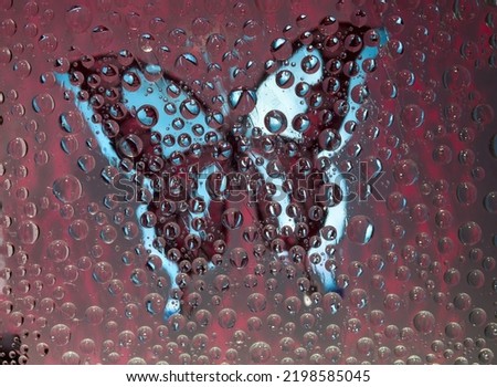Burgundy-blue spheres are located against the vinous background with maroon-blue butterfly silhouette. Abstract fantasy. 3D render.  Foto d'archivio © 