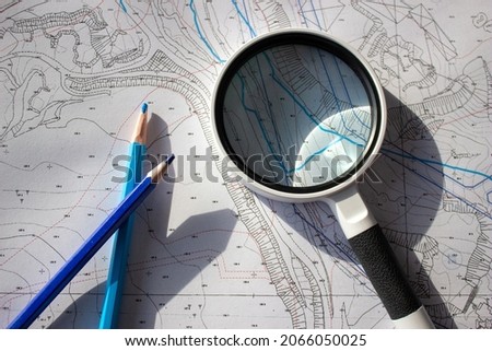 A magnifying glass and pencils on a planning basemap Сток-фото © 