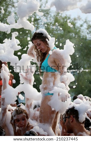 Foam Party on the beach in Igalo, Montenegro, july 26, 2014. Group of people enjoying in drinking, dancing and  music.