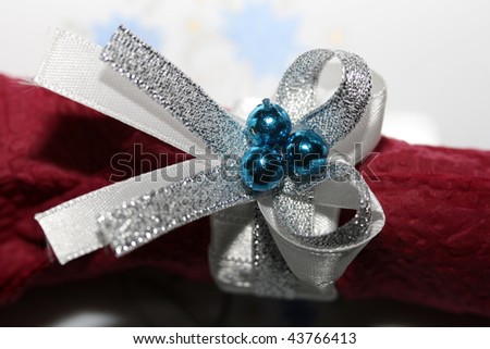 this is a silver bow with blue pearl, napkin holder and decoration.