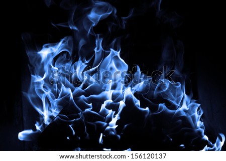 Blue flame isolated on dark background