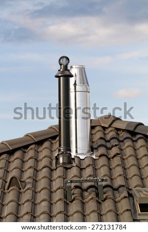 Modern chimney on the roof of house