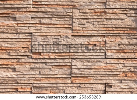 old wall stone tiles background with earth tone