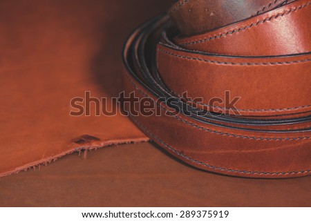 Leather belts over leather background.