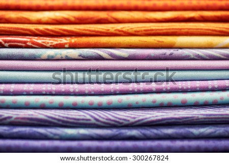 Heap of colorful fabric as a vibrant background image by shallow depth of field focus