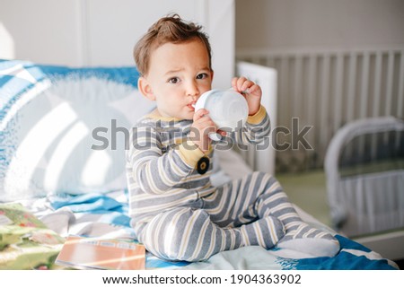 Similar – Image, Stock Photo Toddler drinking milk bottle