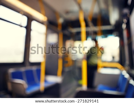 Blurred blurry soft focus background, interior of empty bus with nobody in it