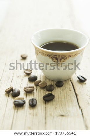 A cup of arabic coffee and beans