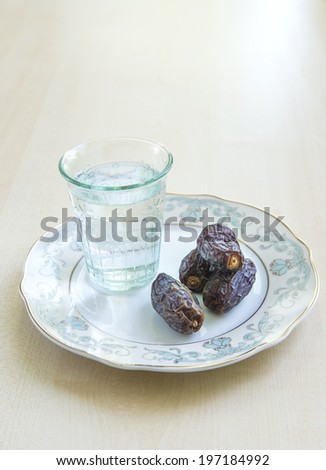 A glass of water and ripe dates - a food that is consumed while breaking fast during holy month of Ramadan