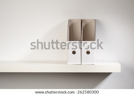 An empty document organizer placed on a shelf.