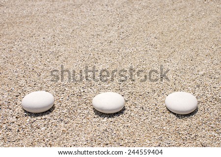 Three stones on the sand