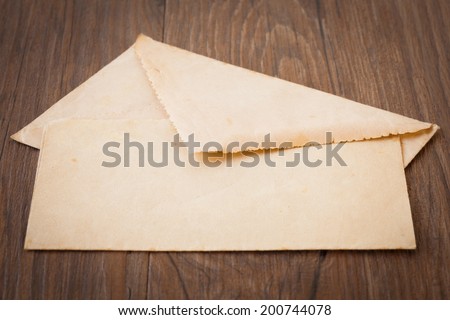 Background of old letters, postcards, photographs and memories, on dark wood