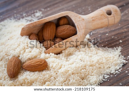 almond flour, almonds in a dark wood background