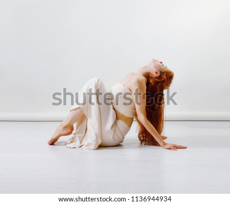 Similar – Image, Stock Photo Young redhead woman sit on grey linen fabric under orange coat with flowers and rowan berries