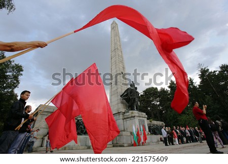 Sofia, Bulgaria - September 9, 2014: People are waving red flags at the ceremony at the Soviet war memorial \