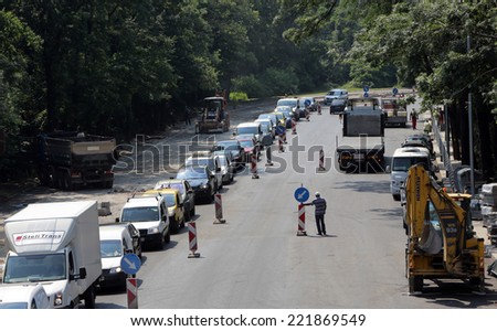 Sofia, Bulgaria - July 7, 2014: Workers are finalizing the last stage of a road repair at one of Bulgaria\'s capital most busy intersections.