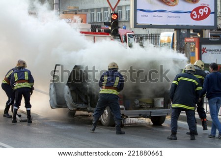 Sofia, Bulgaria - April 4, 2011: Five firefighters are extinguishing a car on fire at main road in Bulgaria\'s capital Sofia.