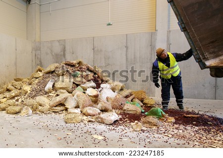 Sofia, Bulgaria - January 28, 2014: Worker is storing chopped sweets near an organic waste plant near Sofia.