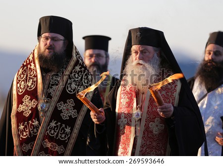 Sofia, Bulgaria - April 11, 2015: Christian priests are delivering the holy fire at Sofia airport. The sacred fire is taken from Jerusalem for Easter.