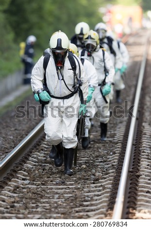 Team working with toxic acid and chemicals is approaching a chemical cargo train crash near Sofia. Teams from Fire department are participating in a training with spilled toxic and flammable materials