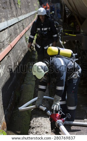 Sofia, Bulgaria - May 19, 2015: Firefighters are extinguishing chemical train tanks. Teams from Fire department are participating in an emergency training with spilled toxic and flammable materials.